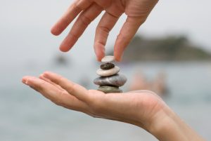 Stacking pebbles in palm of hand