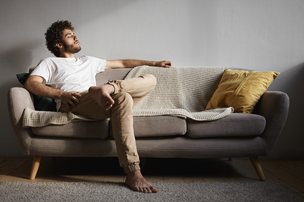 Man relaxing and meditating on a couch